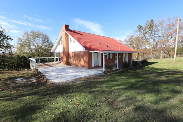 rear view of house with a carport and a lawn