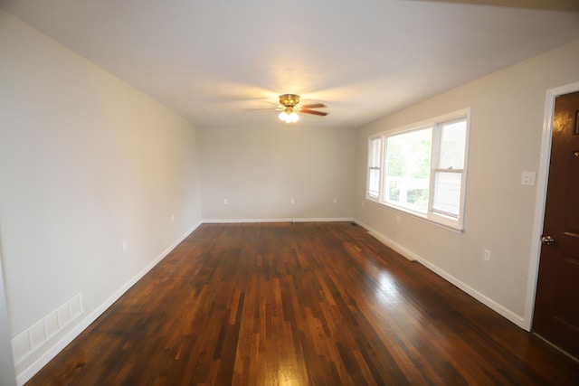 unfurnished room featuring ceiling fan and dark hardwood / wood-style flooring