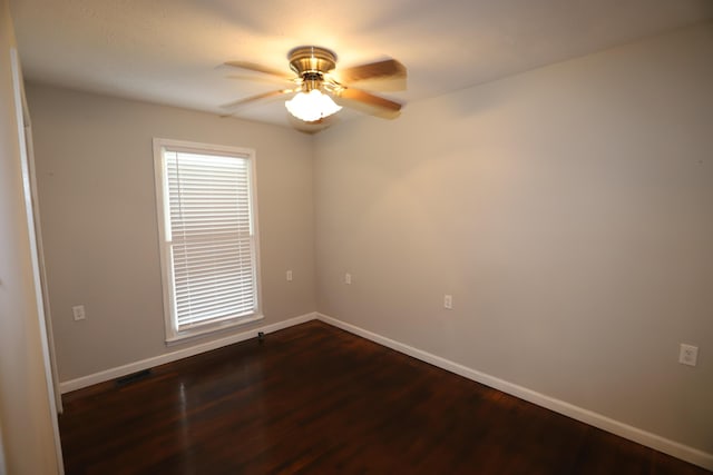 unfurnished room featuring dark hardwood / wood-style floors and ceiling fan