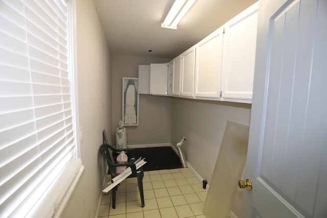 clothes washing area featuring light tile patterned floors