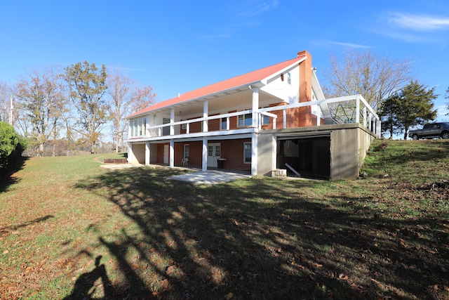 rear view of property with a patio area and a lawn