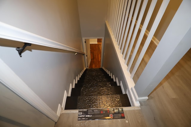 stairs featuring hardwood / wood-style flooring