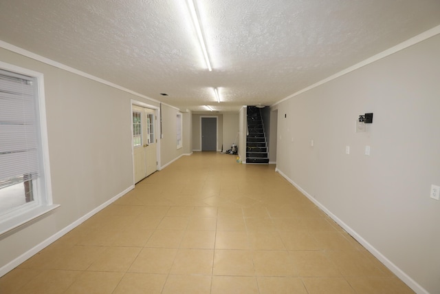 corridor featuring ornamental molding and a textured ceiling