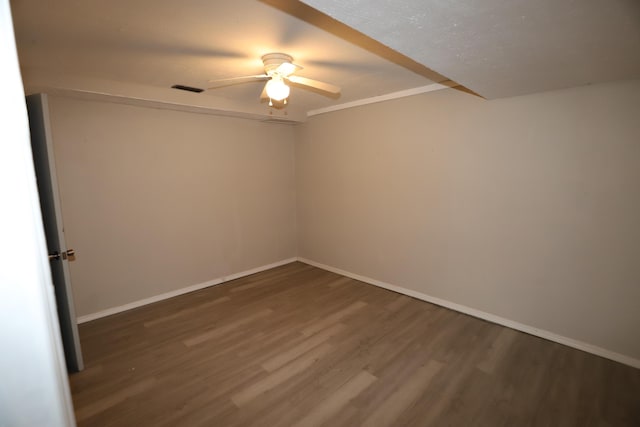 empty room featuring dark hardwood / wood-style flooring and ceiling fan