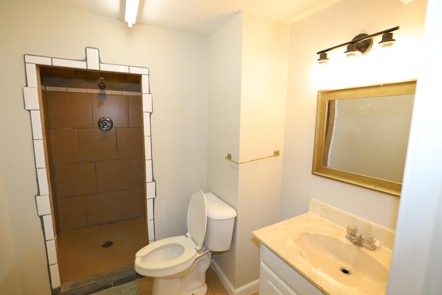 bathroom with vanity, toilet, and a tile shower