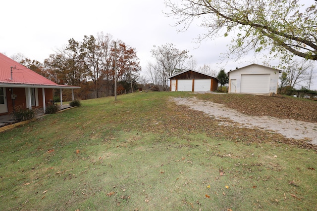 view of yard with a garage and an outdoor structure