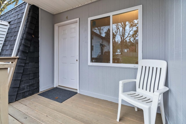 view of exterior entry with a wooden deck