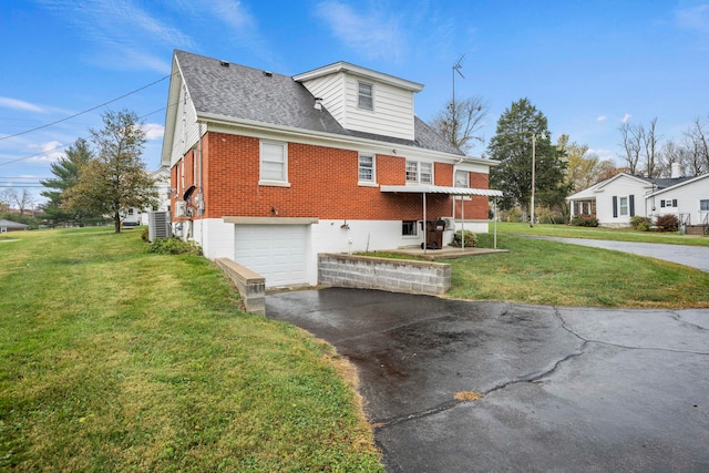 view of home's exterior with a garage and a lawn