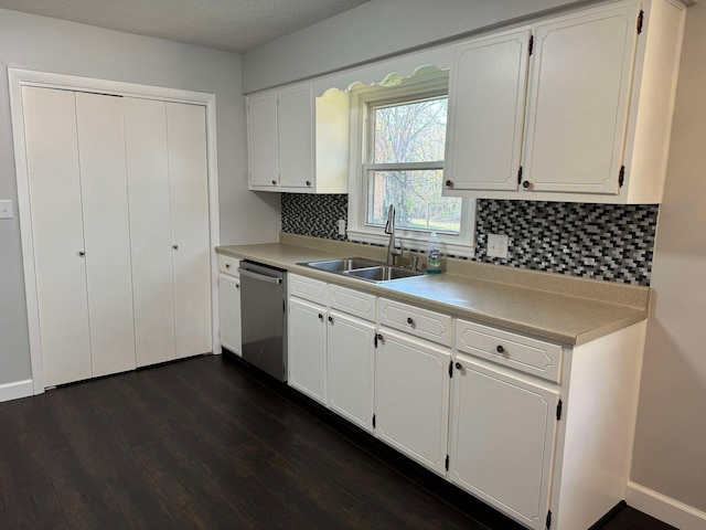 kitchen featuring white cabinetry, dark hardwood / wood-style flooring, stainless steel dishwasher, and sink