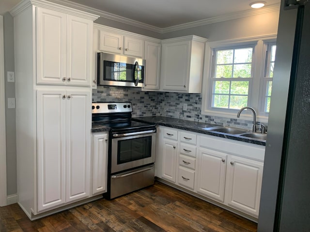 kitchen featuring stainless steel appliances, dark hardwood / wood-style floors, white cabinetry, and sink