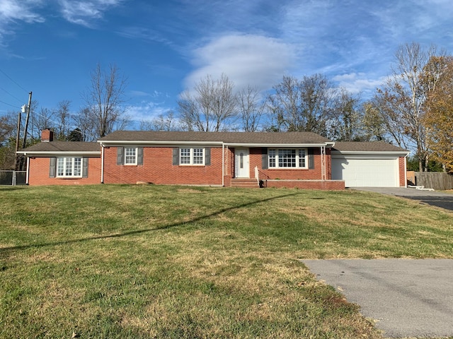 single story home featuring a front lawn and a garage