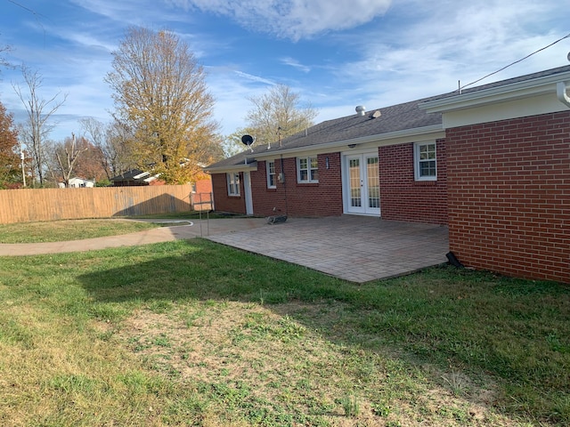 rear view of house featuring a yard, french doors, and a patio area