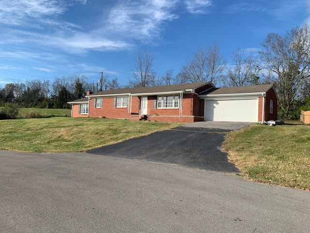 single story home with a garage and a front lawn