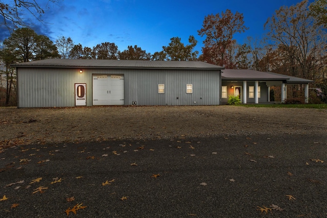 back house at dusk with a garage