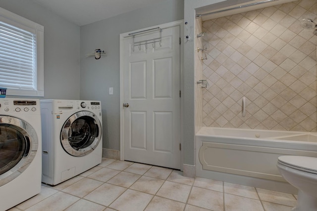 laundry area featuring light tile patterned flooring and independent washer and dryer