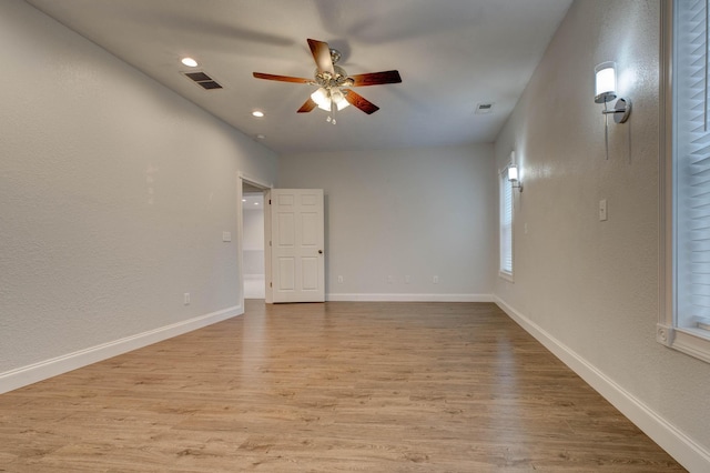 spare room with light hardwood / wood-style flooring and ceiling fan