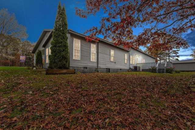 view of side of property featuring central air condition unit and a wooden deck