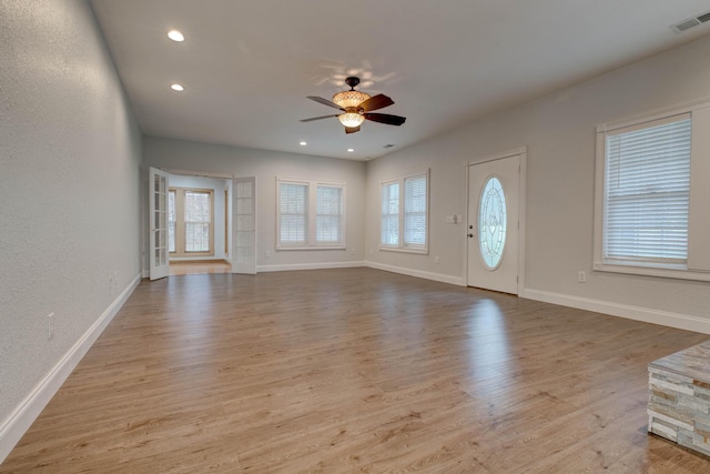 entryway with ceiling fan and light hardwood / wood-style flooring