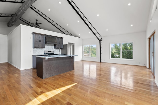 583 College Rd, Paris, KY 40361 - kitchen with high vaulted ceiling, stainless steel appliances, open floor plan, a center island with sink, and light countertops