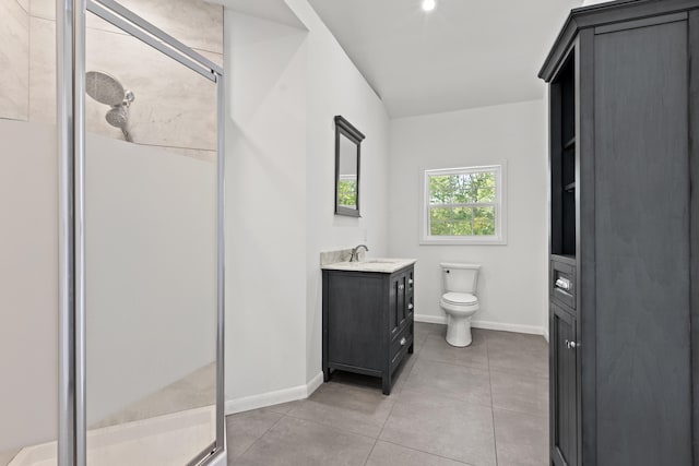 bathroom featuring tile patterned floors, vanity, toilet, and a shower