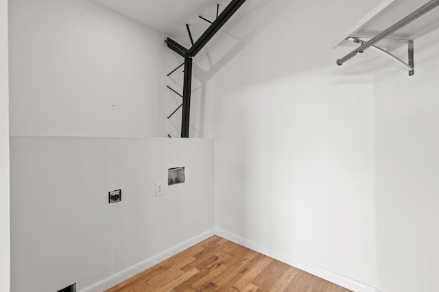 laundry area with electric dryer hookup, hookup for a washing machine, and hardwood / wood-style flooring