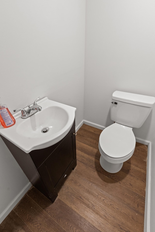 bathroom featuring hardwood / wood-style floors, vanity, and toilet