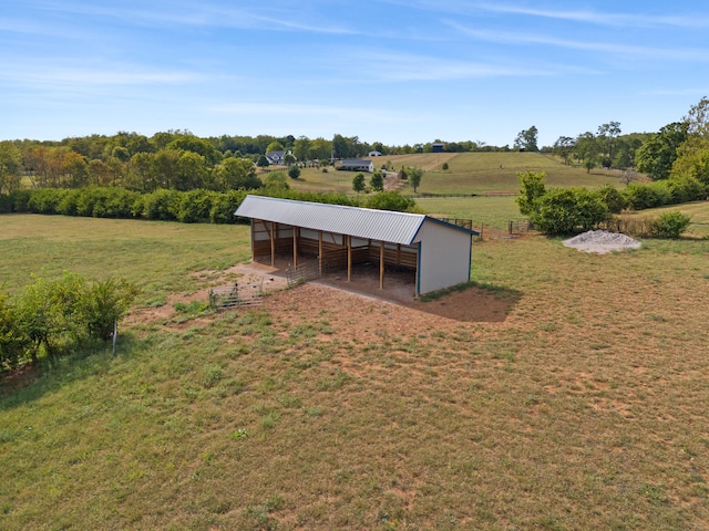 view of yard with a rural view and an outdoor structure