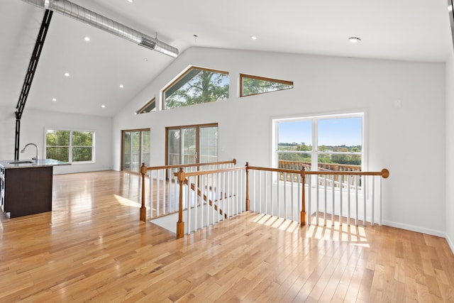583 College Rd, Paris, KY 40361 - corridor with an upstairs landing, light wood-style flooring, high vaulted ceiling, a sink, and recessed lighting