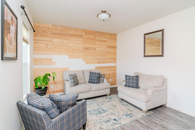 living room with wood walls and hardwood / wood-style floors