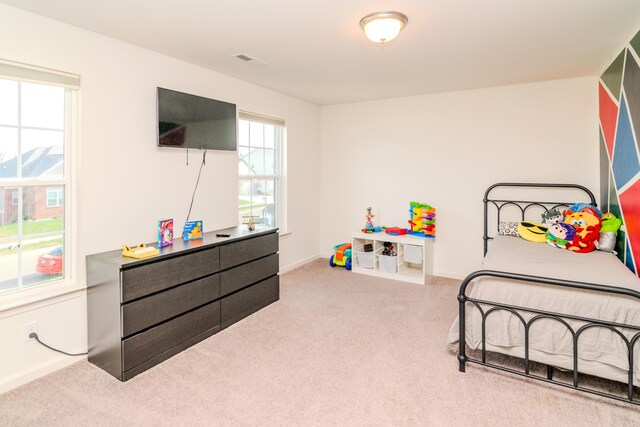 bedroom with light colored carpet