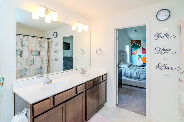 bathroom with toilet, vanity, and curtained shower