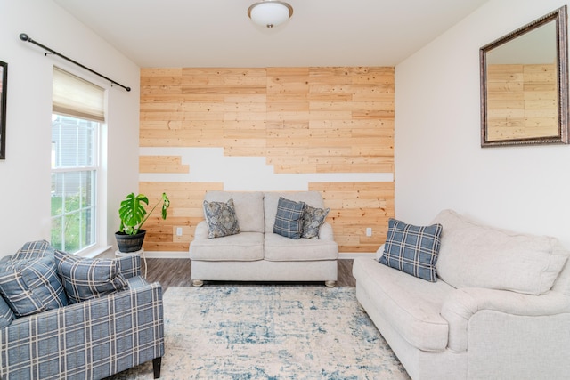 living room with wooden walls and hardwood / wood-style floors