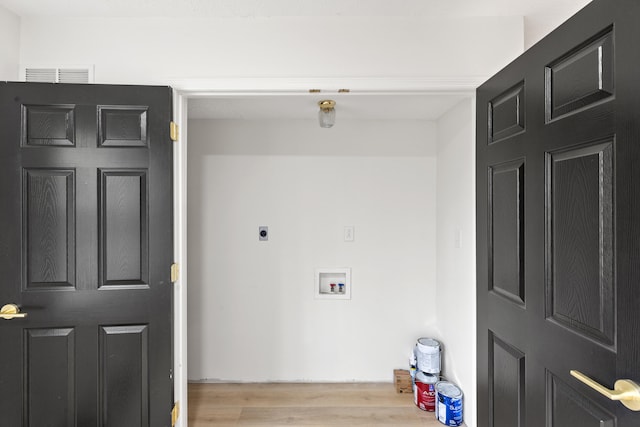 clothes washing area with light hardwood / wood-style floors, hookup for a washing machine, and electric dryer hookup