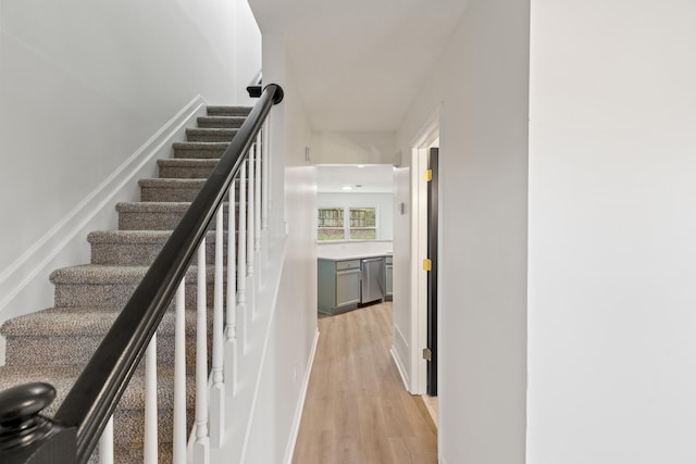 stairs featuring hardwood / wood-style flooring