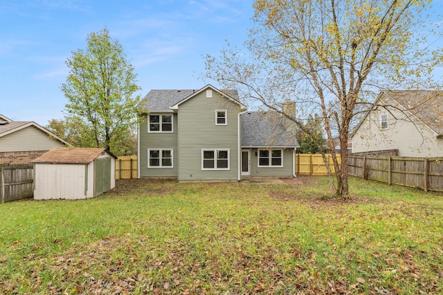 rear view of property with a storage unit and a yard