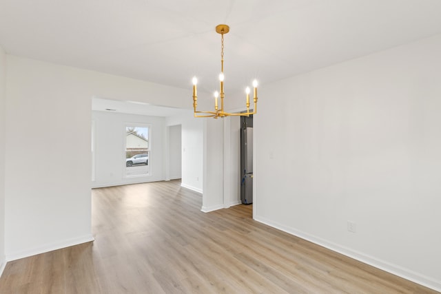 unfurnished dining area with light hardwood / wood-style flooring and a notable chandelier