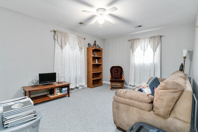 living room featuring carpet flooring and ceiling fan