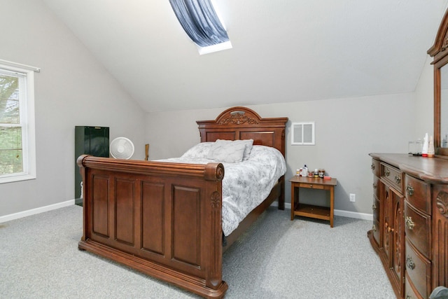 bedroom with light colored carpet and vaulted ceiling