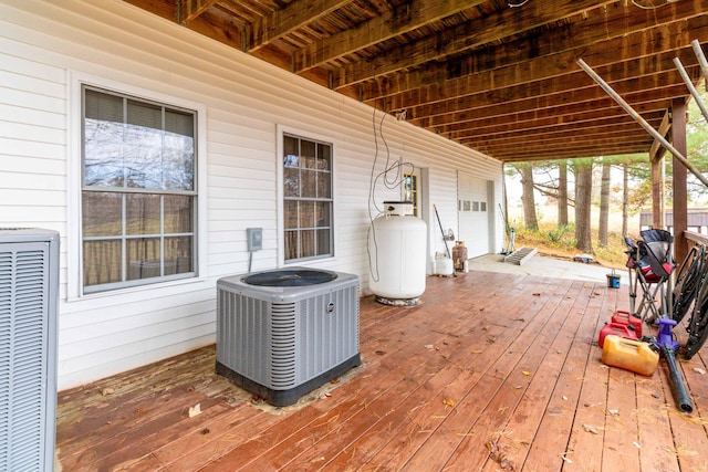 deck with a garage and cooling unit