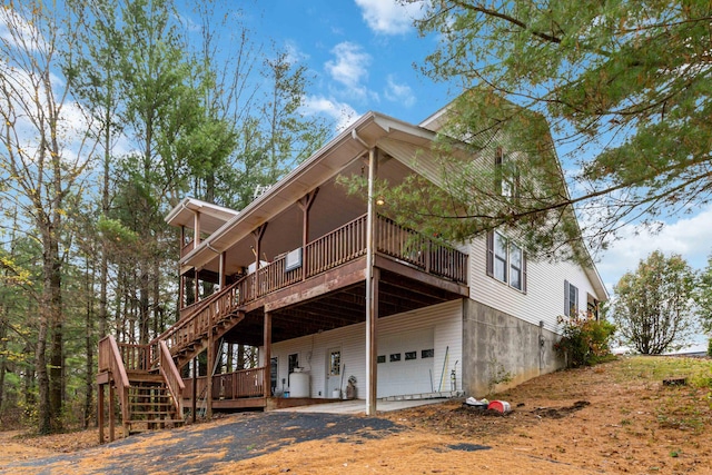 exterior space with a garage and a wooden deck