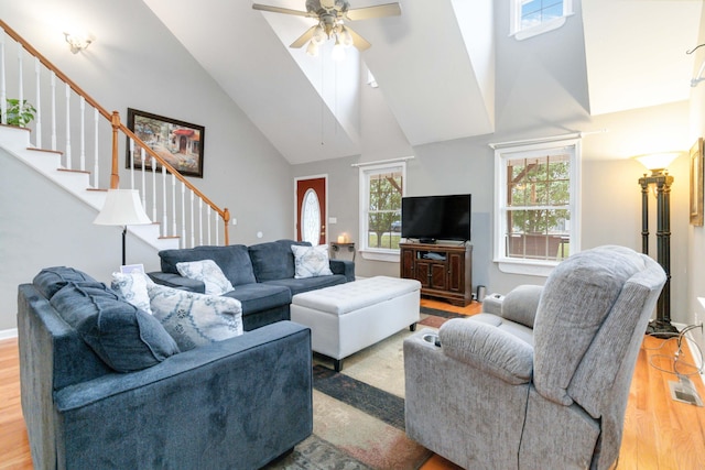 living room with high vaulted ceiling, light hardwood / wood-style floors, and ceiling fan