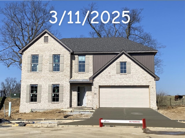 view of front of home with brick siding, driveway, and a shingled roof