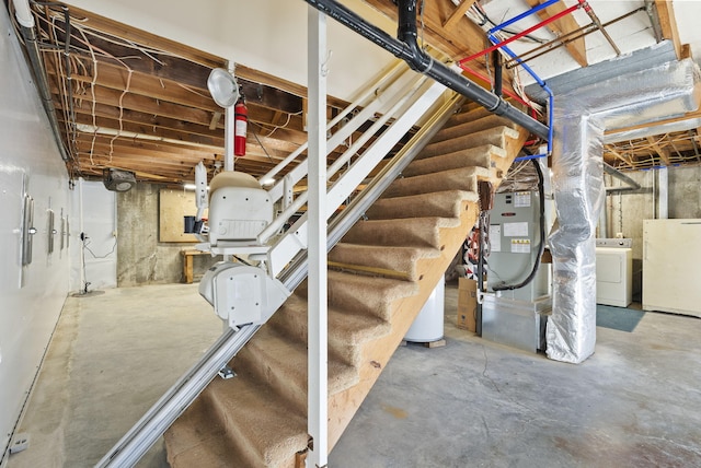 basement featuring white refrigerator, washer / clothes dryer, and heating unit