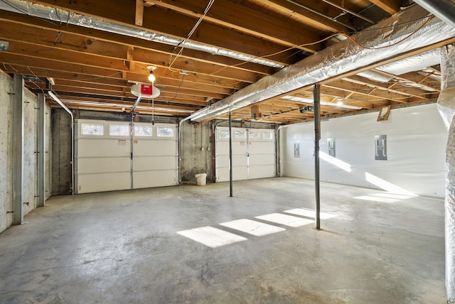 garage with electric panel and a garage door opener