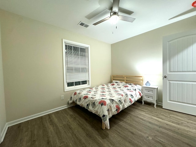 bedroom with ceiling fan and dark hardwood / wood-style floors