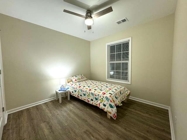 bedroom with ceiling fan and dark hardwood / wood-style floors