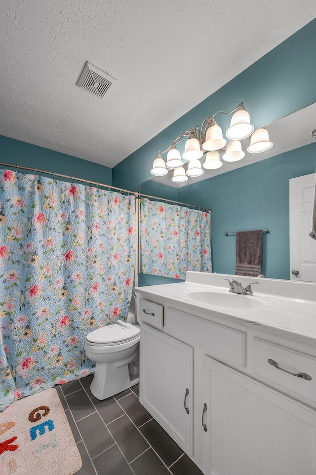 bathroom featuring walk in shower, vanity, a textured ceiling, and toilet