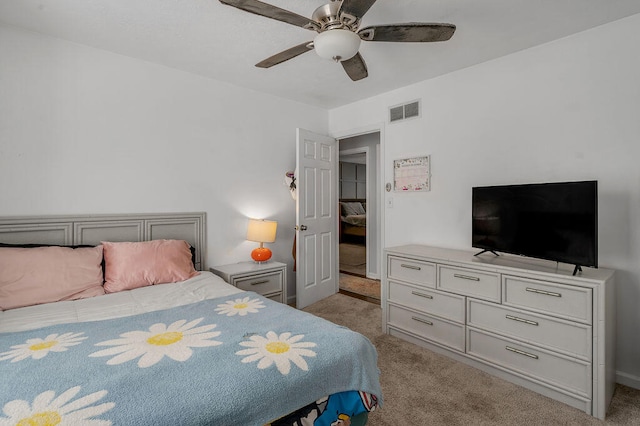 bedroom with ceiling fan and light colored carpet