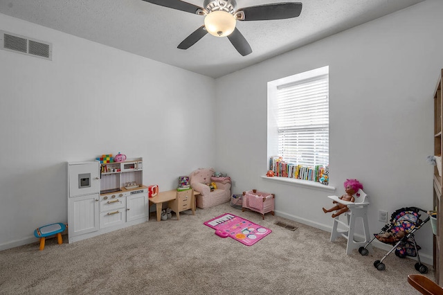 playroom featuring light carpet and ceiling fan