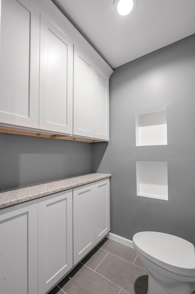 bathroom featuring tile patterned flooring and toilet